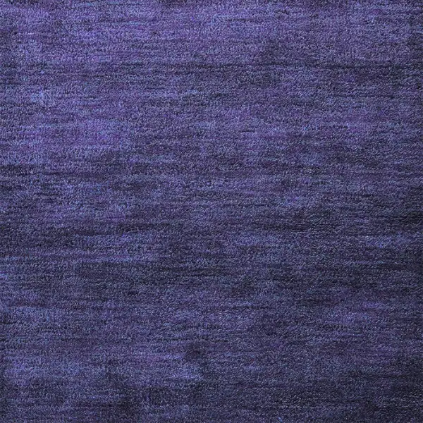 Close-up of deep indigo or violet carpet with a soft, textured surface