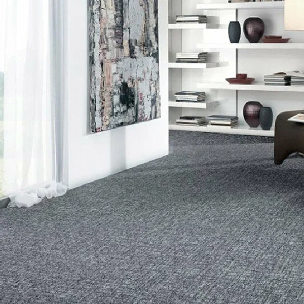 gray wall-to-wall carpet, featuring a white wall with an abstract painting and built-in shelving